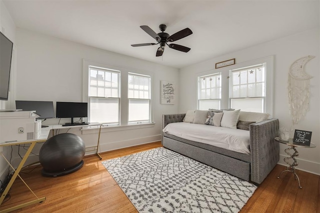 living room featuring hardwood / wood-style flooring and ceiling fan