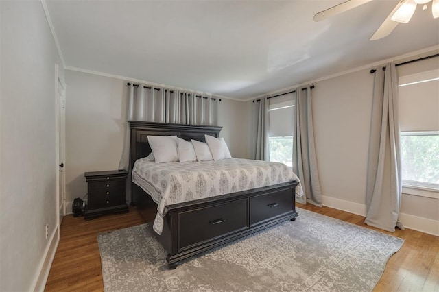 bedroom featuring ceiling fan, light hardwood / wood-style floors, and ornamental molding