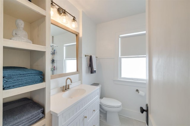 bathroom featuring tile patterned floors, a shower, vanity, and toilet