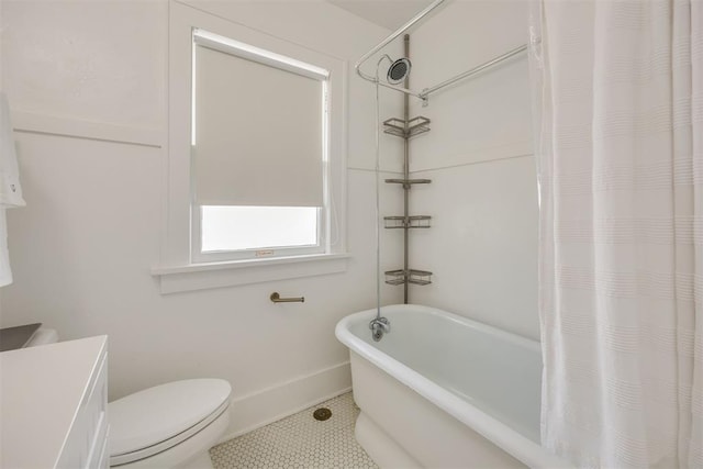 bathroom featuring tile patterned flooring, toilet, and shower / tub combo with curtain