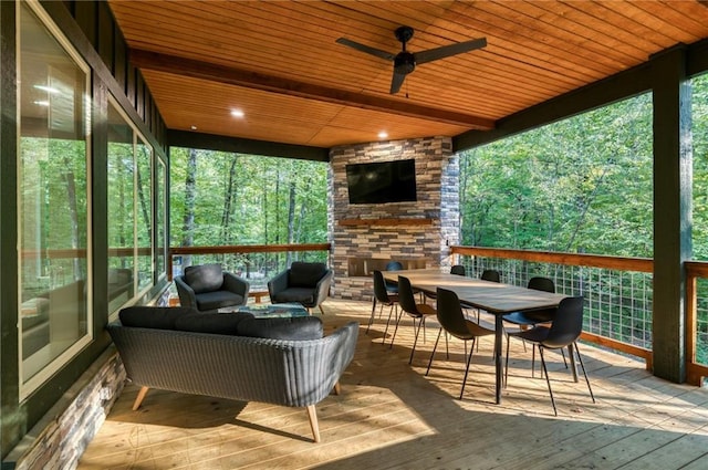 sunroom with ceiling fan and wood ceiling