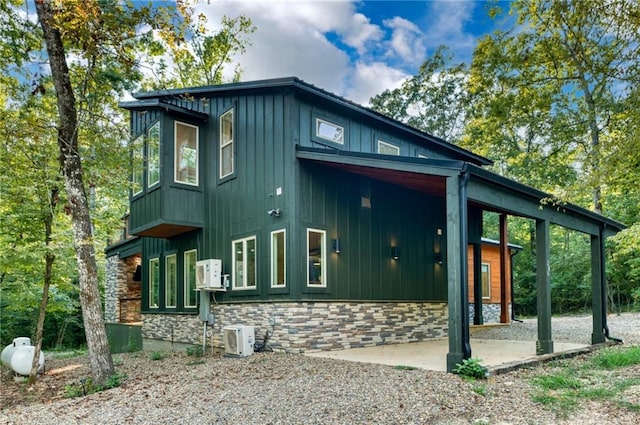 view of side of property with ac unit and a patio