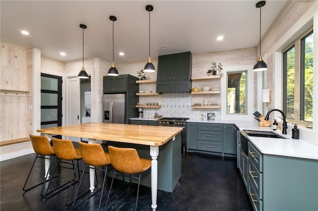 kitchen with a center island, premium range hood, tasteful backsplash, appliances with stainless steel finishes, and pendant lighting