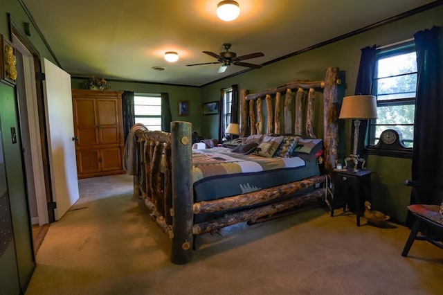 bedroom featuring multiple windows, ceiling fan, and light colored carpet