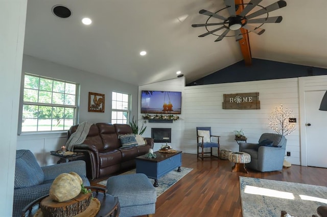 living room with vaulted ceiling with beams, dark hardwood / wood-style floors, and ceiling fan