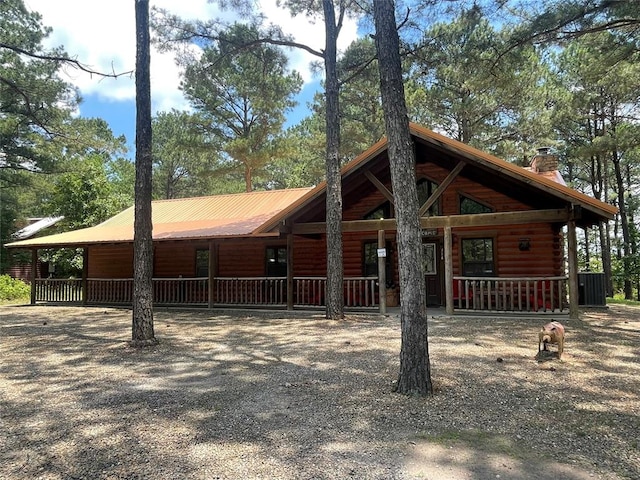 log cabin featuring central air condition unit