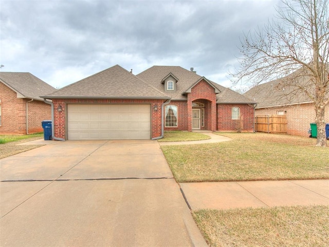 view of front facade with a garage and a front yard