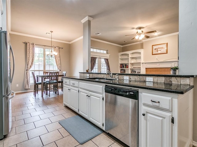 kitchen featuring white cabinetry, sink, hanging light fixtures, stainless steel appliances, and a healthy amount of sunlight