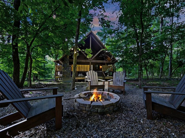 patio terrace at dusk featuring an outdoor fire pit