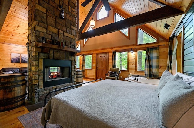 bedroom with beam ceiling, high vaulted ceiling, multiple windows, and wood-type flooring