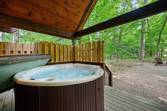 wooden deck featuring a hot tub