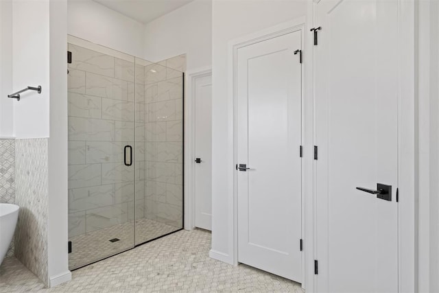 bathroom featuring tile patterned floors and independent shower and bath