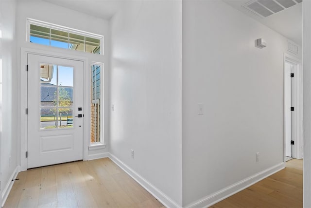 foyer entrance with light hardwood / wood-style floors