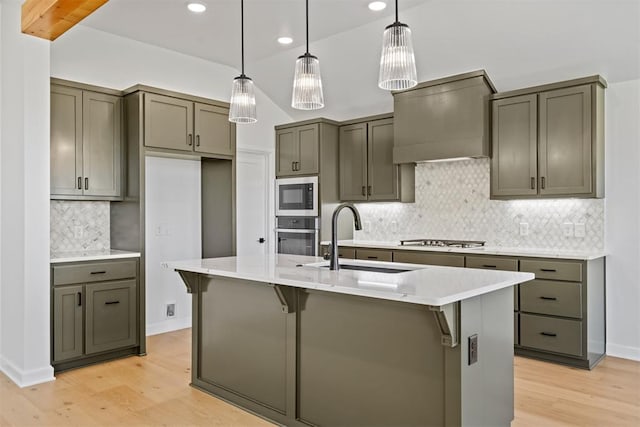 kitchen featuring sink, light hardwood / wood-style flooring, decorative backsplash, custom range hood, and stainless steel appliances