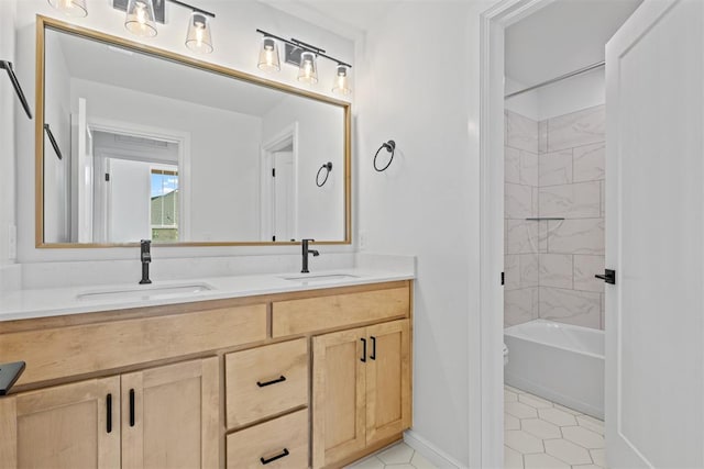 bathroom featuring tile patterned flooring, vanity, and tiled shower / bath