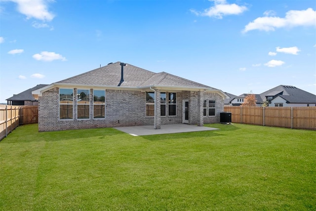 back of house with a lawn, a patio, and central AC unit