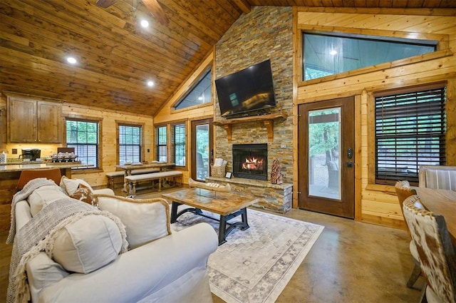 living room with wooden ceiling, high vaulted ceiling, and concrete flooring