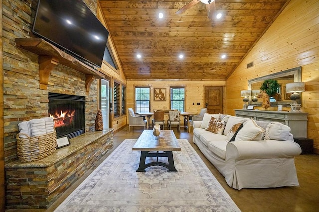 living room with wood walls, a stone fireplace, wood ceiling, and high vaulted ceiling