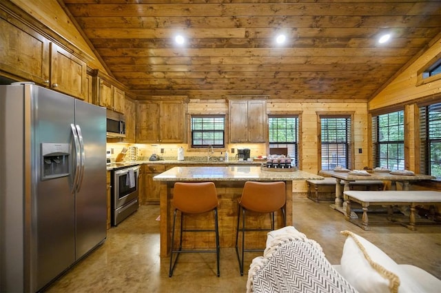 kitchen featuring a center island, wood ceiling, appliances with stainless steel finishes, and vaulted ceiling