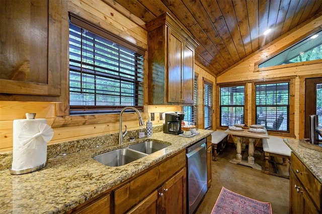 kitchen with dishwasher, a healthy amount of sunlight, and wooden walls