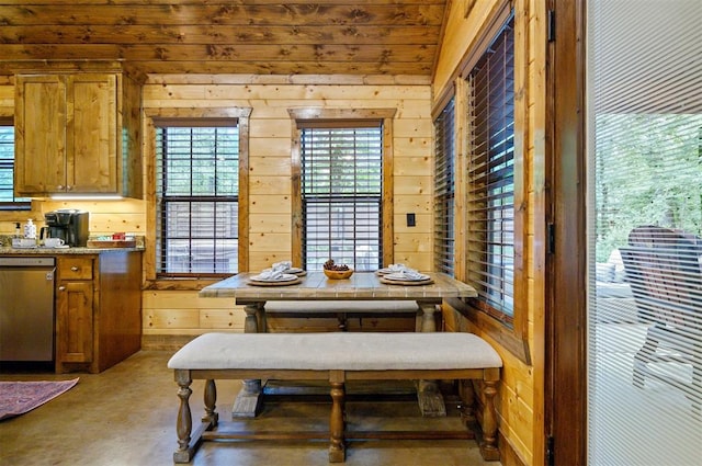 dining space featuring vaulted ceiling, wood ceiling, and wood walls