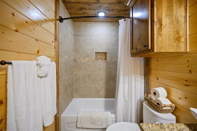 bathroom with wooden walls, shower / tub combo with curtain, and toilet