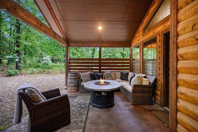 view of patio with an outdoor living space with a fire pit