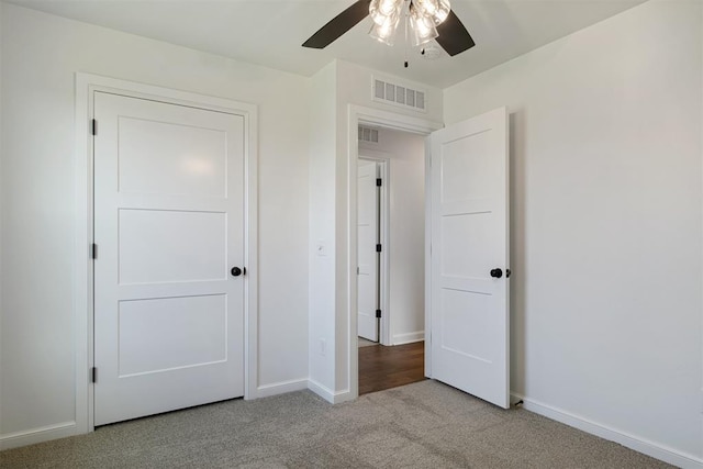 unfurnished bedroom with ceiling fan and light colored carpet