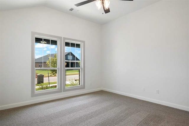 empty room with ceiling fan, carpet, and vaulted ceiling