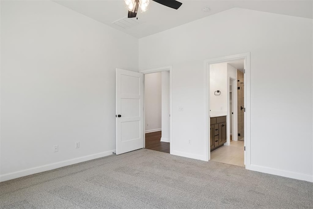 unfurnished bedroom with high vaulted ceiling, ceiling fan, light carpet, and connected bathroom