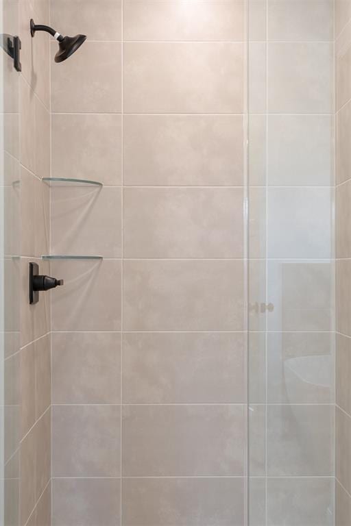 bathroom with a tile shower