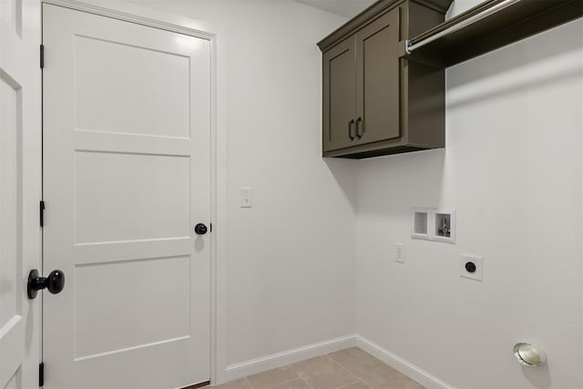 washroom featuring washer hookup, light tile patterned floors, cabinets, and hookup for an electric dryer