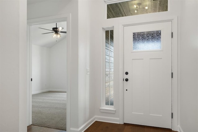 foyer featuring dark hardwood / wood-style floors, vaulted ceiling, and ceiling fan