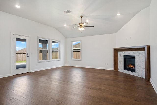 unfurnished living room featuring lofted ceiling, a fireplace, ceiling fan, and dark hardwood / wood-style floors