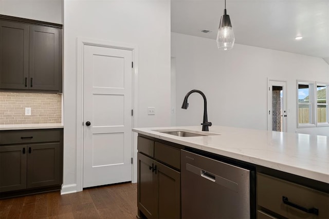 kitchen featuring light stone counters, stainless steel dishwasher, sink, decorative light fixtures, and dark hardwood / wood-style floors