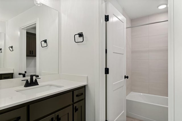 bathroom with vanity and tiled shower / bath combo