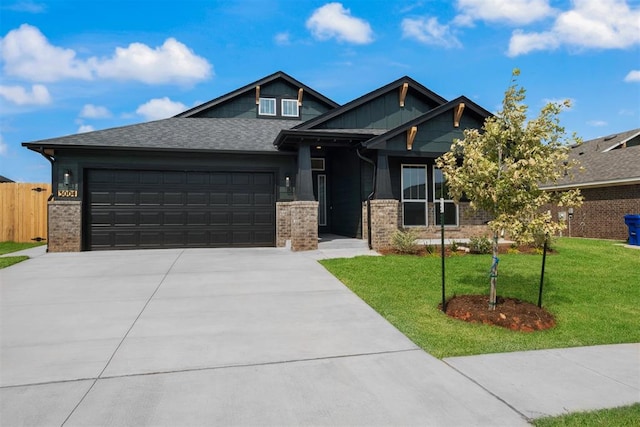 craftsman-style house featuring a front yard and a garage