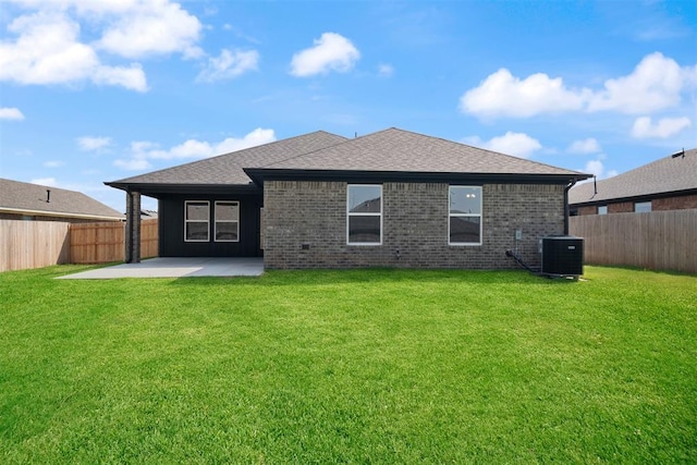 back of property with central AC unit, a patio area, and a lawn