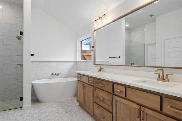 bathroom featuring tile walls, vanity, independent shower and bath, and lofted ceiling