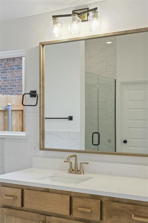 bathroom with vanity and a shower with shower door