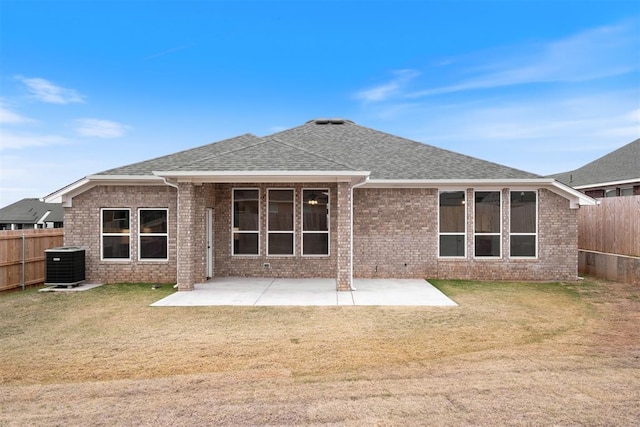 back of property with a yard, a patio area, and central air condition unit