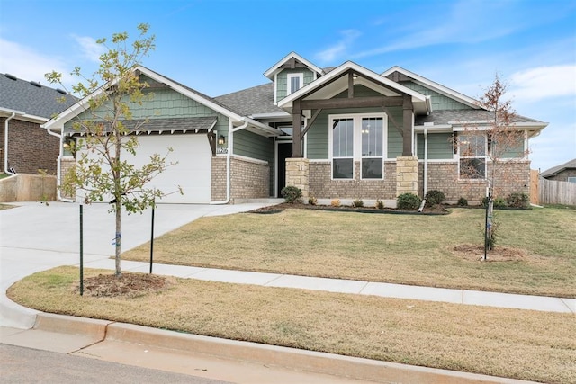 craftsman house with a front lawn and a garage