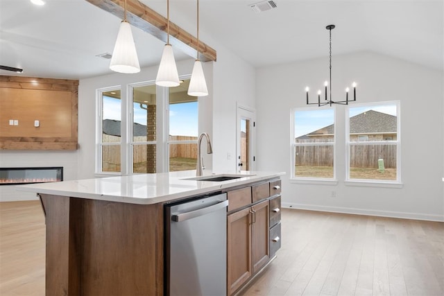 kitchen with light wood-type flooring, stainless steel dishwasher, a healthy amount of sunlight, and sink