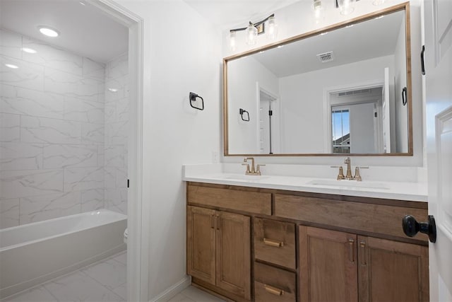 full bathroom with toilet, vanity, and tiled shower / bath combo