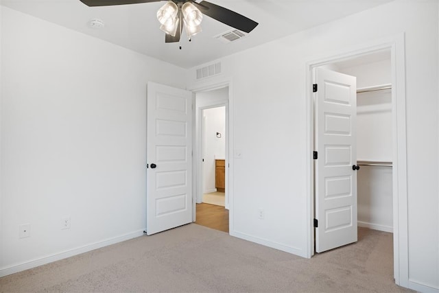 unfurnished bedroom with a closet, ceiling fan, and light colored carpet