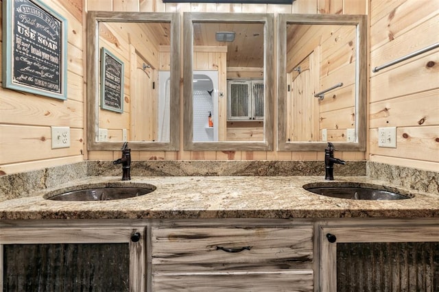 bathroom featuring wooden walls and vanity