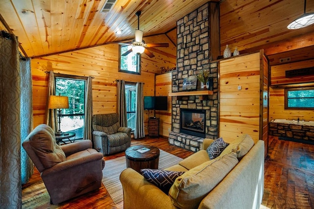 living room with a stone fireplace, plenty of natural light, dark wood-type flooring, and wood ceiling