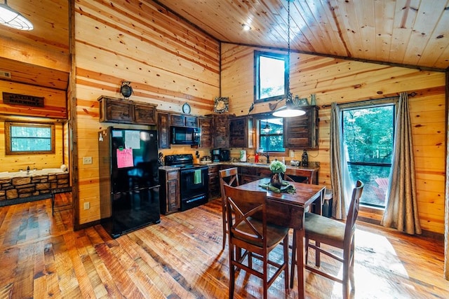 dining space featuring wood ceiling, wooden walls, sink, high vaulted ceiling, and light hardwood / wood-style flooring