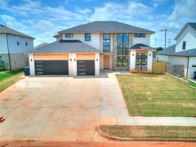 view of front of property with a front yard and a garage