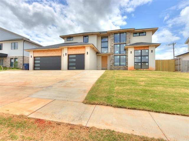 view of front of house with a front yard and a garage